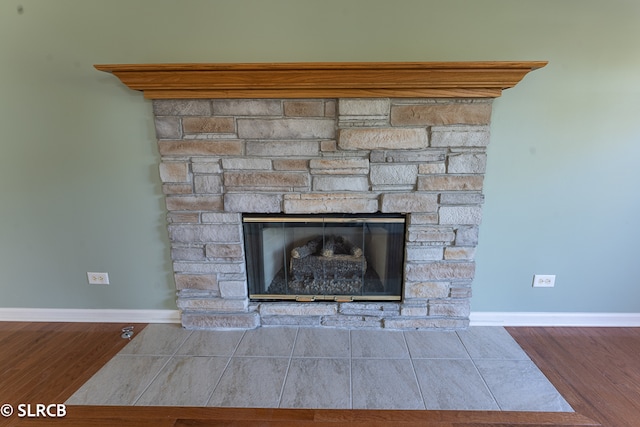 interior details featuring a fireplace and wood-type flooring