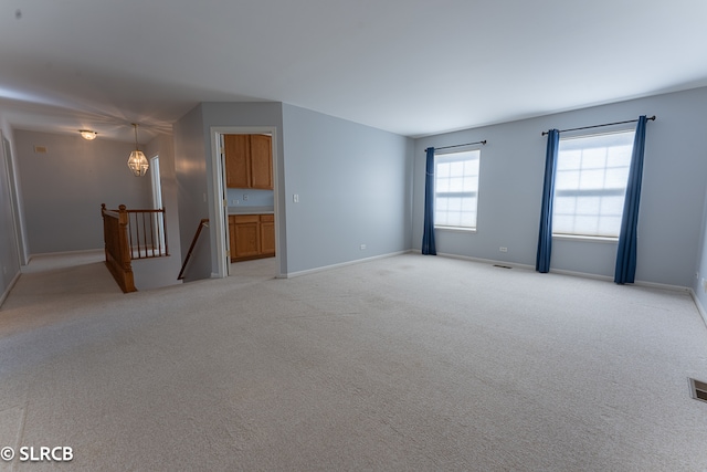 unfurnished room with light colored carpet