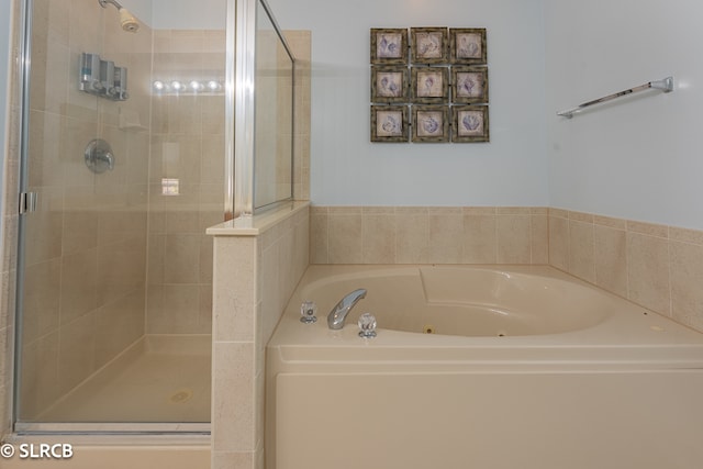 bathroom featuring shower with separate bathtub