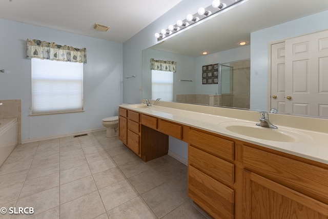 full bathroom with tile patterned flooring, vanity, separate shower and tub, and toilet