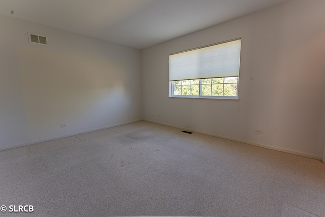 empty room with light colored carpet