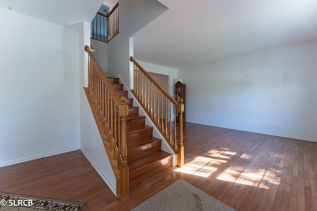 staircase with hardwood / wood-style flooring