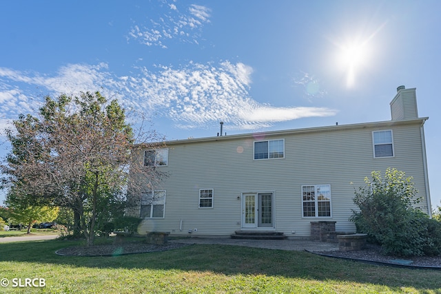 rear view of property with a yard