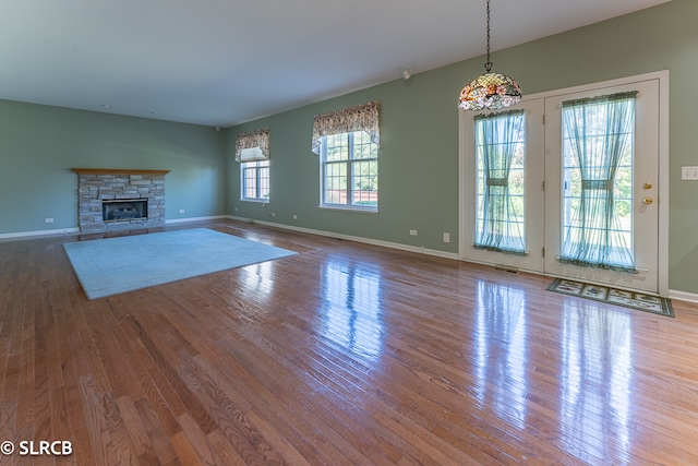 unfurnished living room with a fireplace and light hardwood / wood-style floors