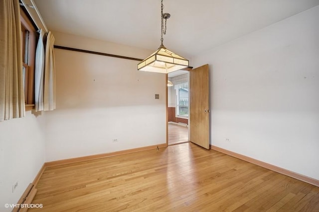 1087 Cedar Ln, Northbrook, IL 60062 - unfurnished room with wood finished floors, baseboards, and baseboard heating