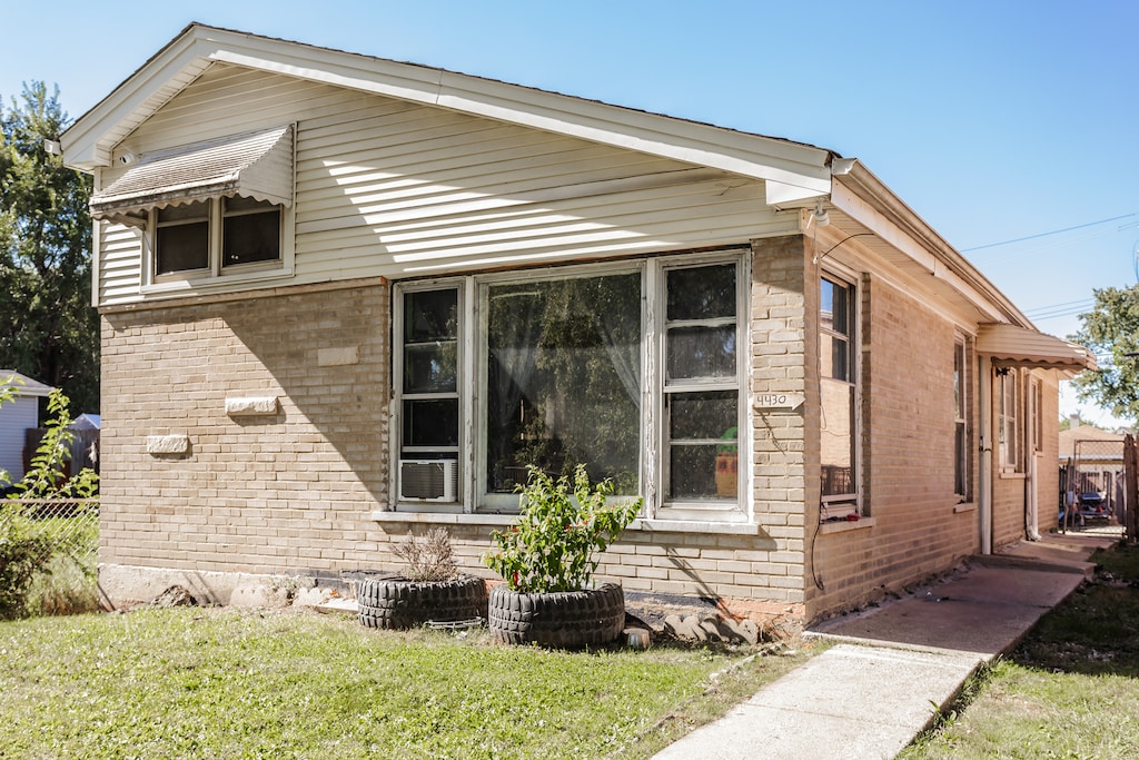 view of side of home with a lawn