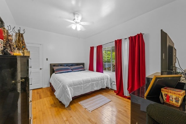 bedroom with ceiling fan and hardwood / wood-style flooring