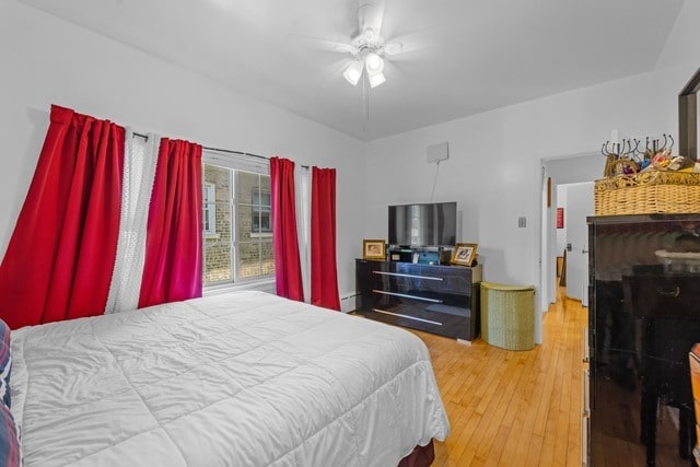 bedroom featuring wood-type flooring and ceiling fan