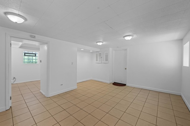 spare room featuring light tile patterned floors