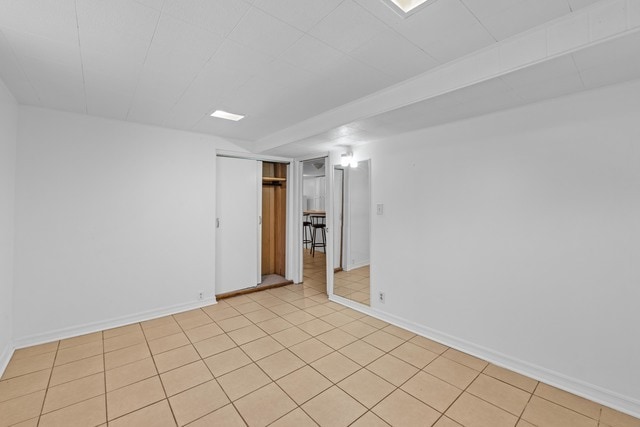 unfurnished room with light tile patterned floors