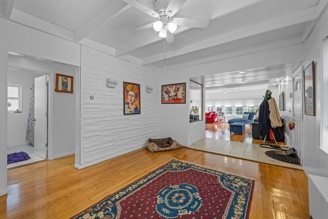 interior space with beam ceiling and wood-type flooring