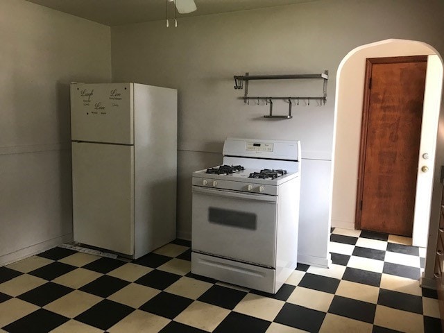 kitchen featuring ceiling fan and white appliances