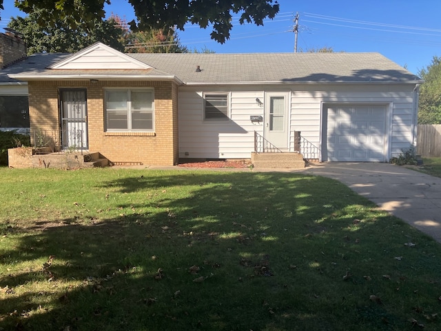 single story home featuring a front lawn and a garage