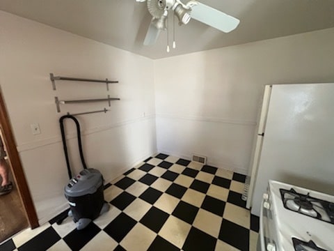 interior space with ceiling fan and white refrigerator