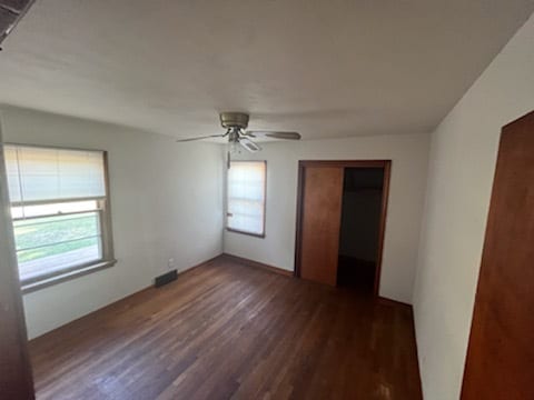 unfurnished room with ceiling fan and dark hardwood / wood-style floors