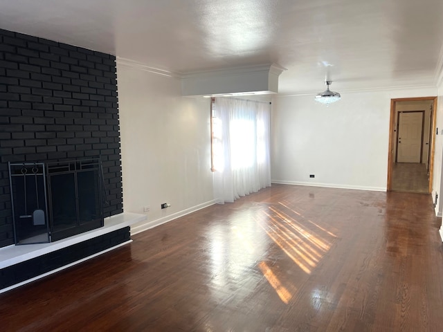 unfurnished living room with ornamental molding, dark wood-type flooring, and a fireplace