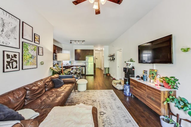 living room featuring ceiling fan and dark wood-type flooring