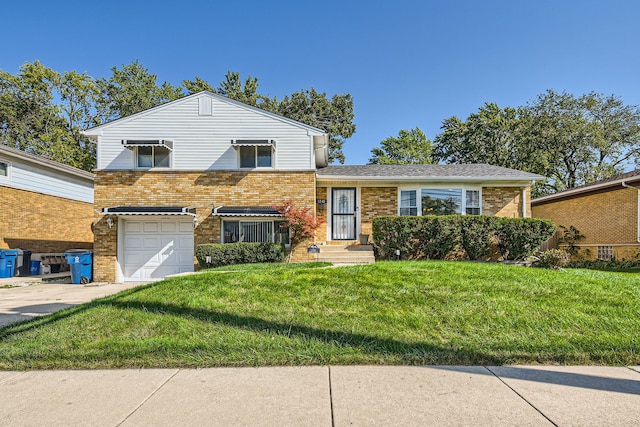 tri-level home featuring a front yard and a garage