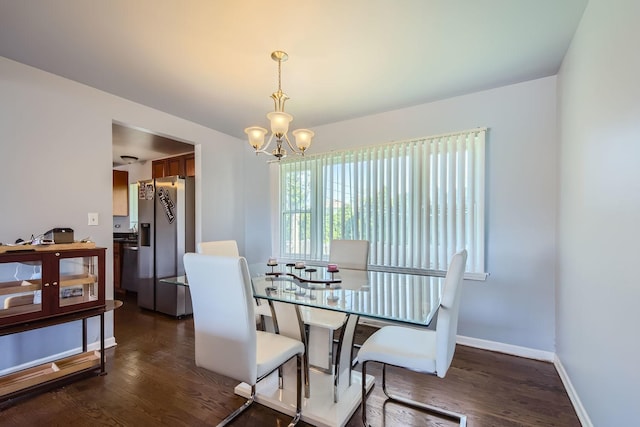 dining room featuring a notable chandelier and dark hardwood / wood-style flooring