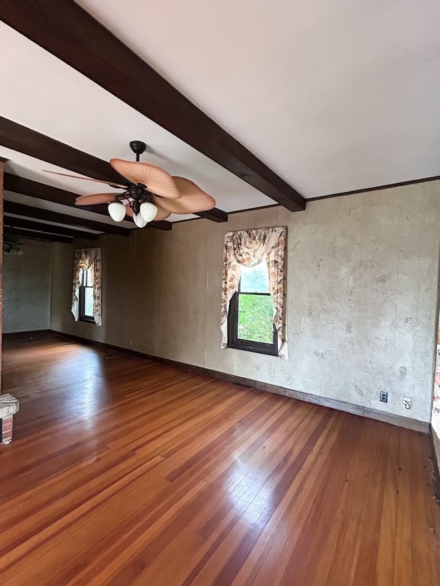 unfurnished room featuring ceiling fan, beam ceiling, and hardwood / wood-style floors