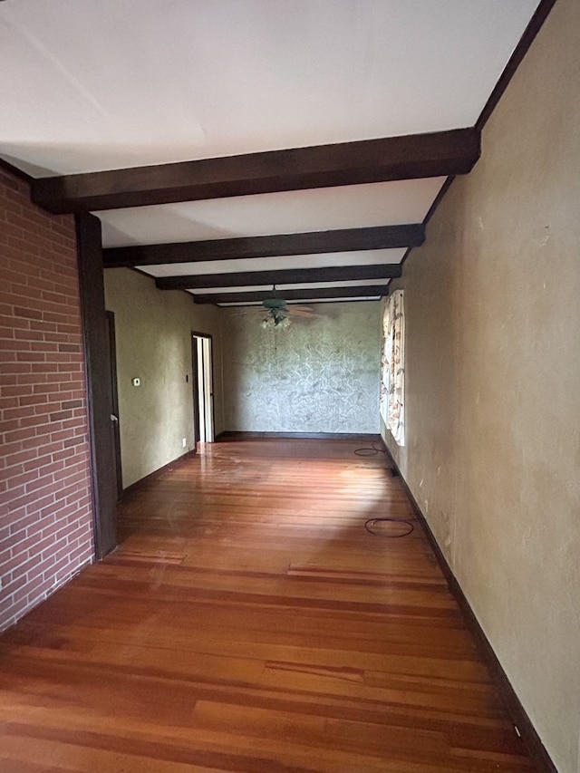 hallway with beamed ceiling and hardwood / wood-style flooring