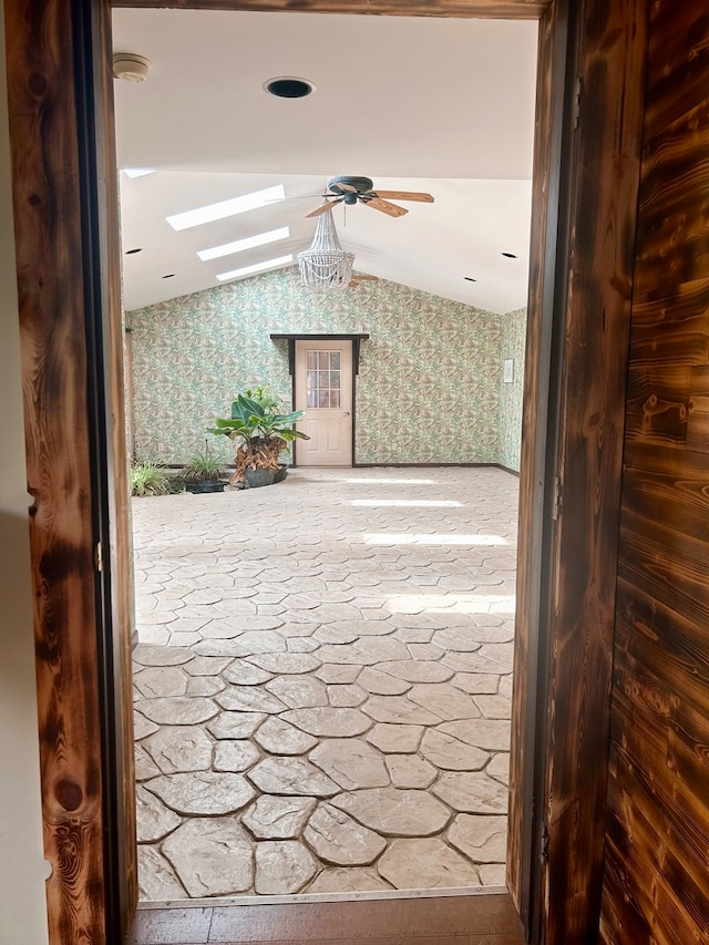 corridor featuring lofted ceiling with skylight