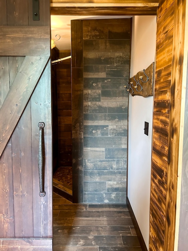 interior space featuring hardwood / wood-style flooring and wooden walls