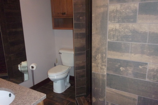 bathroom featuring tile patterned flooring, vanity, and toilet