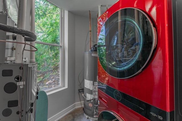 laundry area featuring gas water heater and stacked washing maching and dryer