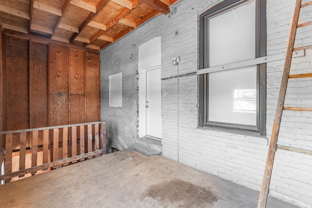 interior space featuring brick wall and concrete floors