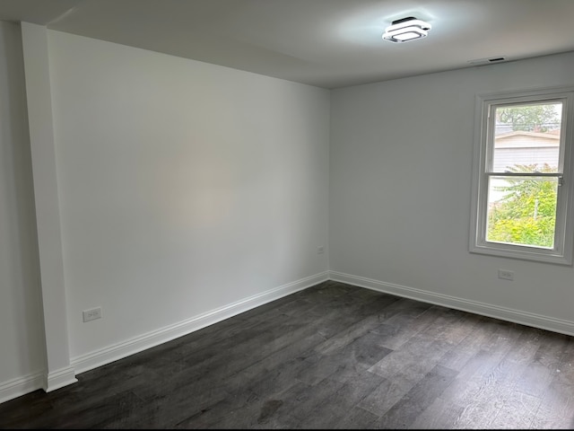 empty room featuring dark hardwood / wood-style flooring