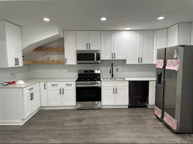 kitchen with stainless steel appliances, sink, and white cabinetry