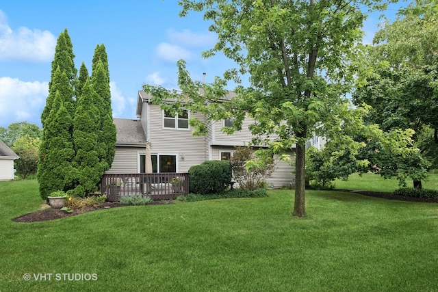 rear view of property with a lawn and a deck