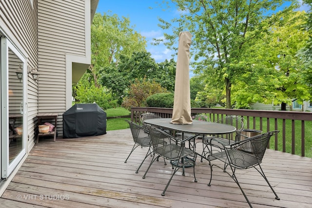 wooden deck with area for grilling and a yard