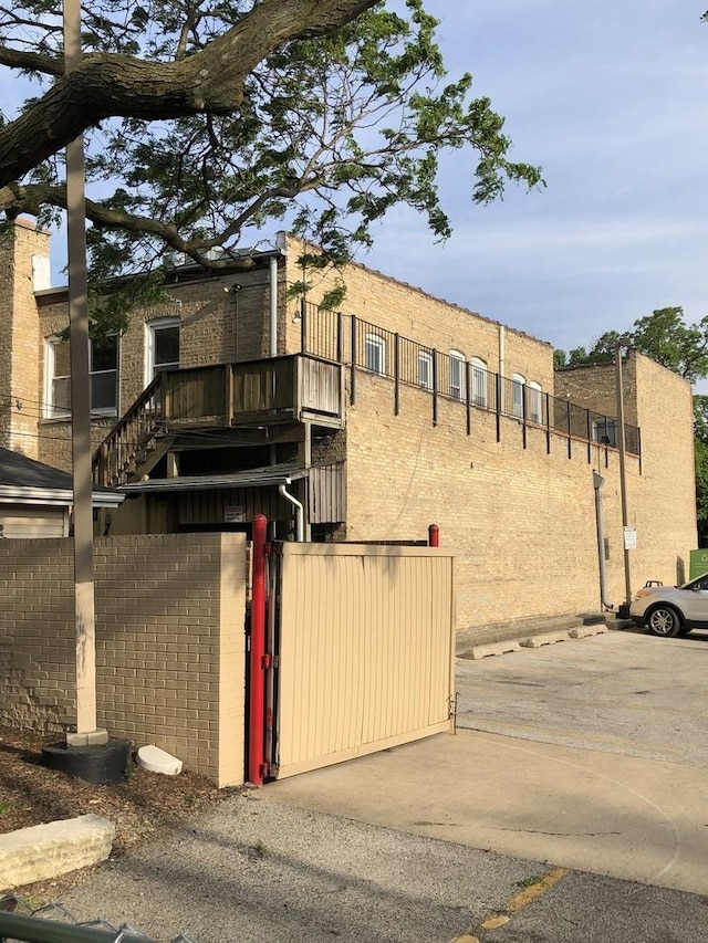 1813 Dempster St, Evanston, IL 60201 - exterior space featuring brick siding, uncovered parking, fence, and a gate