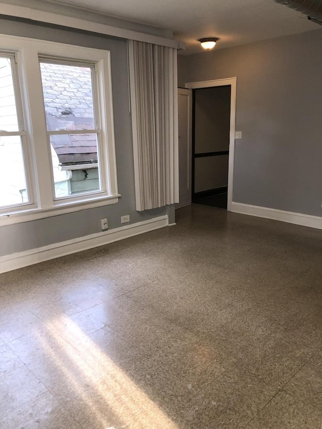 1813 Dempster St, Evanston, IL 60201 - spare room with baseboards, plenty of natural light, and dark floors