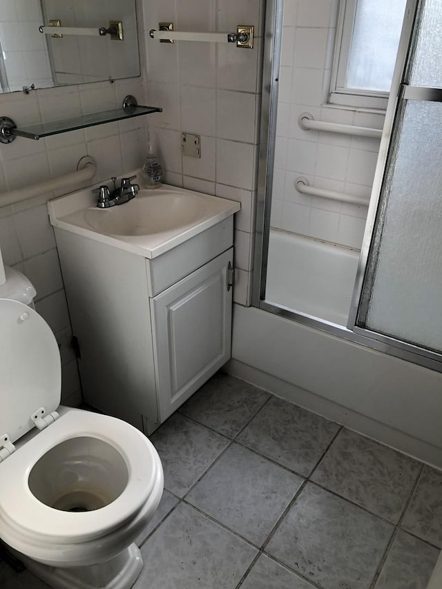 1813 Dempster St, Evanston, IL 60201 - bathroom with vanity, enclosed tub / shower combo, tile patterned flooring, toilet, and tile walls