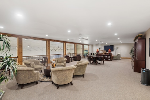 living room with ceiling fan, light carpet, and a wealth of natural light