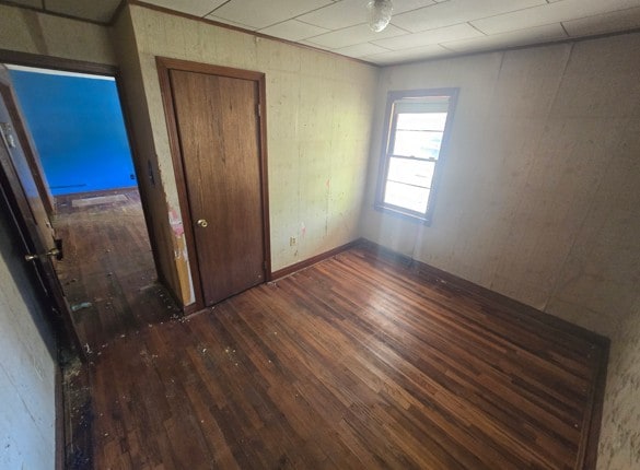 unfurnished bedroom with dark hardwood / wood-style floors