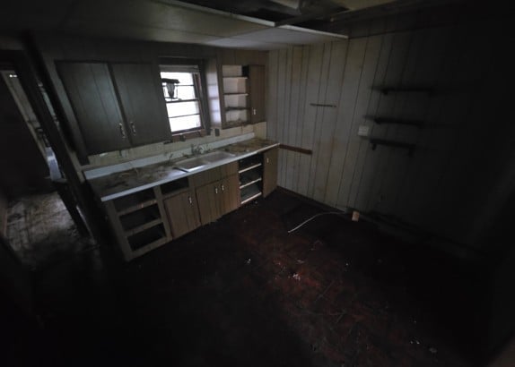 basement with wooden walls and sink