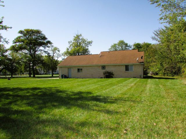 back of house with a yard