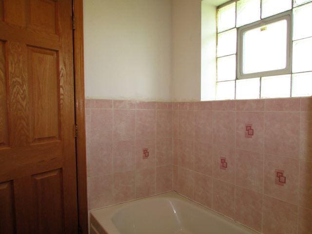 full bathroom with a tub to relax in