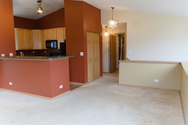 kitchen with kitchen peninsula, light brown cabinetry, refrigerator, light colored carpet, and hanging light fixtures