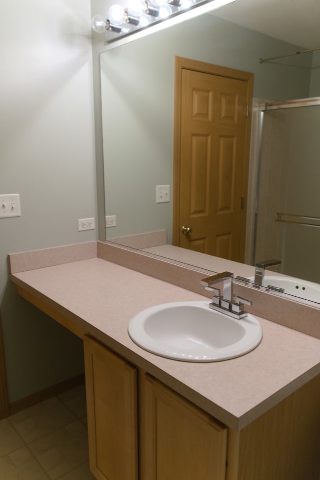 bathroom with tile patterned flooring, vanity, and a shower with shower door