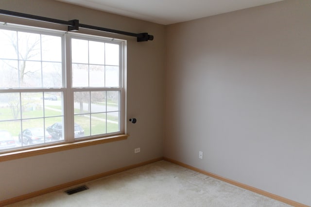 unfurnished room with light colored carpet