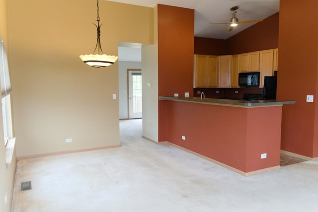 kitchen with ceiling fan, light brown cabinets, kitchen peninsula, light colored carpet, and decorative light fixtures