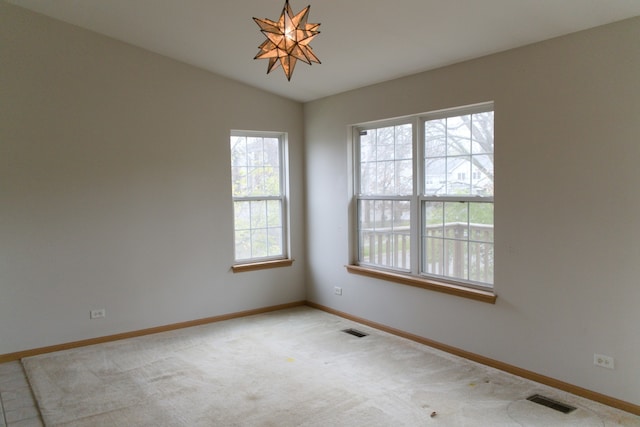 empty room with lofted ceiling and light carpet