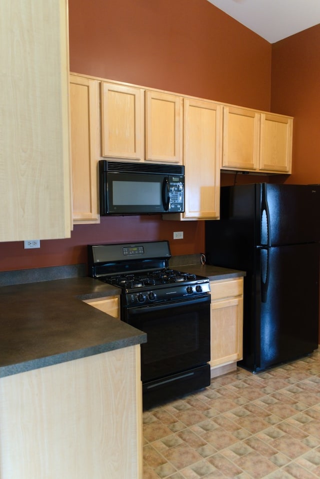 kitchen with black appliances and light brown cabinets