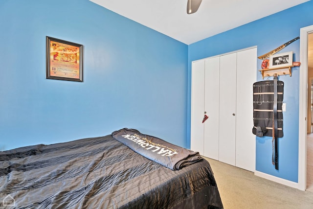 carpeted bedroom with a closet and ceiling fan