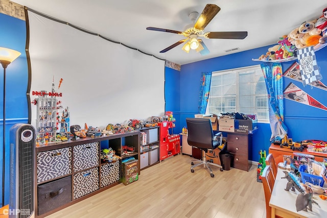 home office with ceiling fan and light hardwood / wood-style flooring